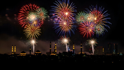 Vibrant fireworks explode above city skyline at night with festive atmosphere and colorful display