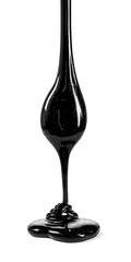Isolated splash of crude oil with shiny texture and thick drip lines on clean white surface