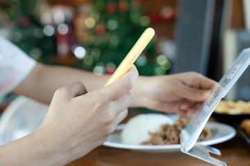 Woman use smartphone to scan QR code to pay in cafe restaurant with a digital payment without cash. Choose menu and order accumulate discount. E wallet, technology, pay online, credit card, bank app.