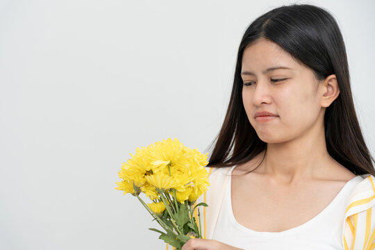 Pollen Allergies, asian young woman sneezing in a handkerchief or blowing in a wipe, allergic to wild spring flowers or blossoms during spring. allergic reaction, respiratory system problems