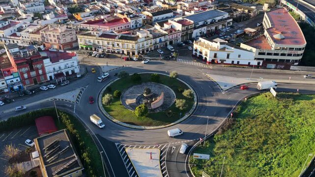 Perspective drone view of Monumento al Toreo statue in the middle of busy roundabout with cars, Camas, Sevilla, Spain