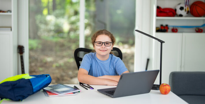 Kid studying at home school with laptop and books. Child doing homework during homeschool lesson. Young student learning in home school environment. Boy focused on study at home school desk. - Powered by Adobe