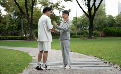 Happy meeting Asia mature with Asia young man in the park
