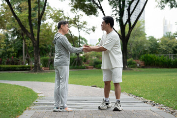 Happy meeting Asia mature with Asia young man and hand shake in the park