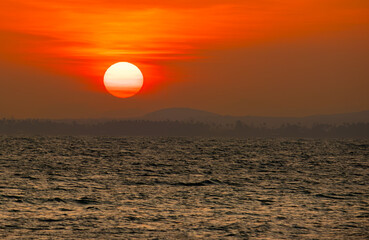 Golden sunset over tranquil sea—perfect for travel ads, nature screensavers, or peaceful...