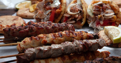 Mixed grilled meat platter, pork and chicken meat skewers, kebab pieces, closeup