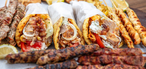 Gyro sliced meat pita bread wraps and kebab pieces, traditional street food, closeup