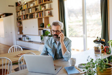 Man working from home while on phone call.