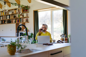 Man working from home while on phone call.
