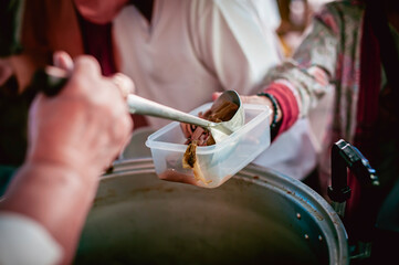 The hands of the hungry get food from the hands of volunteers, Food Donations for Homeless