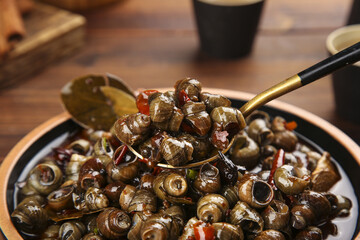 Stir-Fried Snails with Spicy Peppers and Chopsticks © ThachThi