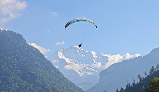 tandem paragliding with snowcapped Jungfrau Swiss Alps in Interlaken