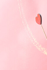 Romantic heart with glowing golden particles create a dreamy Valentine's scene, perfect for celebrating love, affection, and togetherness.