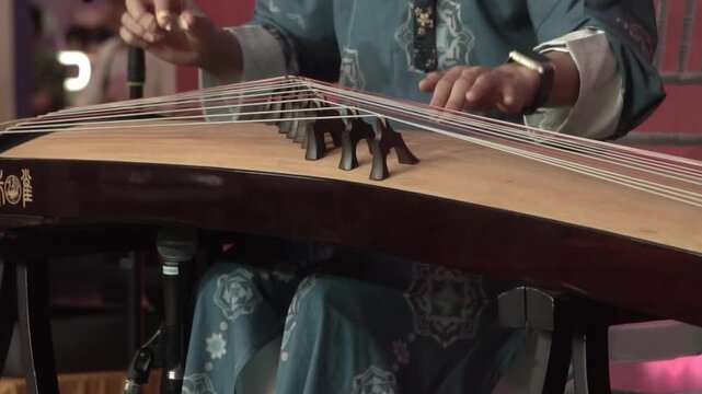 Chinese traditional musician playing Chinese guzheng