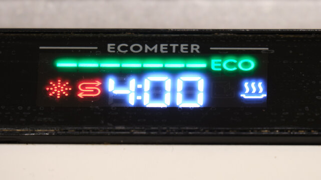 Dishwasher control panel showing eco mode and warning icons. Close-up of a dishwasher display at startup showing ECO indicator, cycle time, and illuminated warning symbols for user attention. - Powered by Adobe
