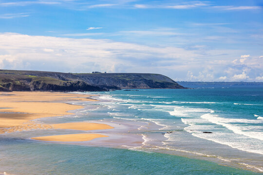 Awesome view at a beach with breaking waves on the coast in Bretagne