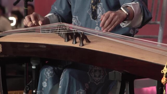 Chinese traditional musician playing Chinese guzheng