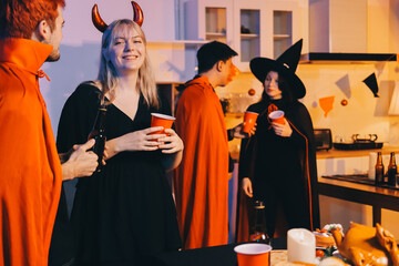 Friends enjoying a Halloween party at a bar making a toast