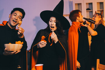 Friends enjoying a Halloween party at a bar making a toast