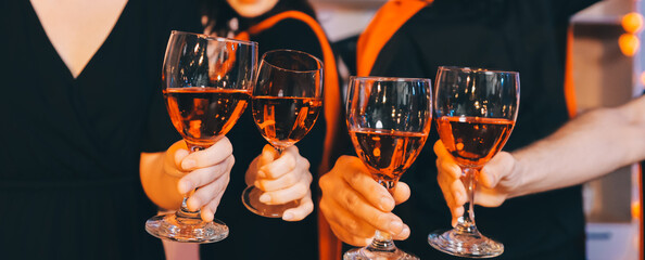 Friends enjoying a Halloween party at a bar making a toast