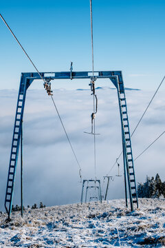 Ski Lift Towers Above Winter Clouds