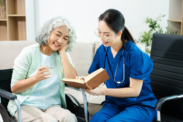 Obraz premium Asian nurse consulting elderly woman in wheelchair at home. Senior care, home healthcare, nursing support, communication and caregiver concept