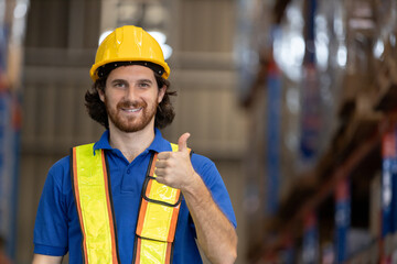 Smiling warehouse worker giving thumbs up gesture in storage facility, representing positivity, team spirit, satisfaction in logistics and supply chain operations.