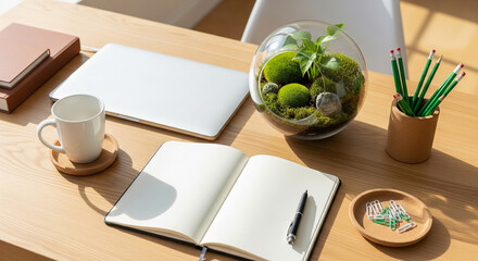 Bright and organized desk with open notebook, laptop, and desk plants creating a productive workspace.