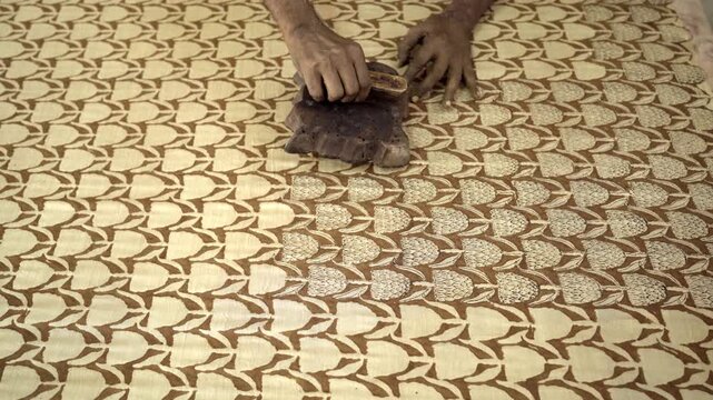 Closeup of artisan handblock printing in organic cotton textile