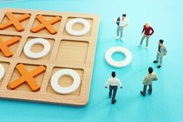 Concept image of miniature people solving puzzle. idea of teamwork and success