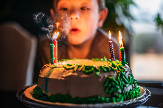 Boy Blowing Out birthday Cake Candles
