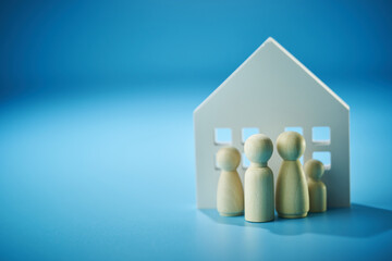 Family people figures and wooden house model