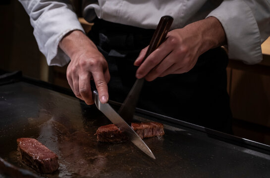 Chef preparing beef at yakiniku restaurant in Osaka