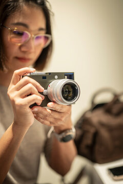 woman with luxury range finder camera