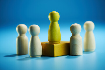 Symbolic leadership concept with leader elevated above the crowd.