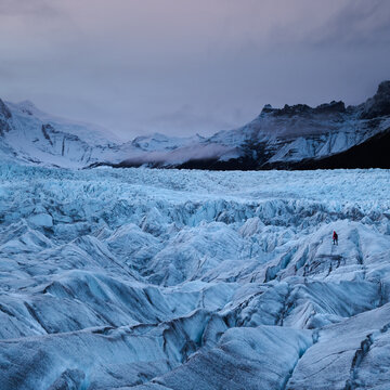 Moody Light and Svinasfelljokull, Hiker Dwarfed by Glacier