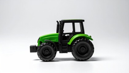 Fototapeta premium Green Toy Tractor on White Background - Farm Vehicle.