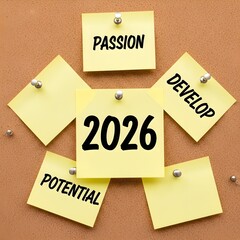2026 vision board with yellow sticky notes on cork bulletin board, motivational concept with words passion, develop, and potential for new year goals.