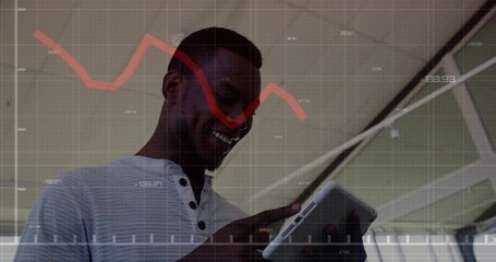 Animation of financial data processing african american businessman using tablet - Powered by Adobe