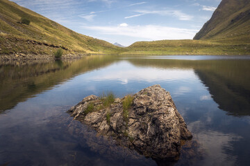 Beautiful reflections at Escunhau Lake in Vall d'Aran, Catalonia