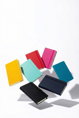 Seven colorful pocket notebooks floating in a circular arrangement on a white background.