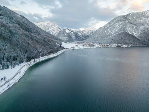 snow covered mountain lake achensee in austria with pertisau winter landscape