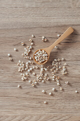 Natural Ingredients Variety with Wooden Spoon and Raw Seeds on Table