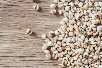 White grains scattered on wooden surface in natural light setting