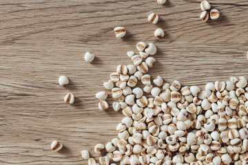 Organic Whole Grains Piled on Wooden Surface Spilling Natural Ingredients