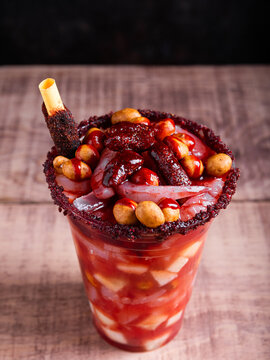 Crazy little glass, a mixture of sweet, salty and spicy ingredients. Typical snack from Mexico