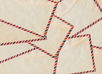 Vintage airmail envelopes arranged in a repeating pattern forming a textured postal paper background