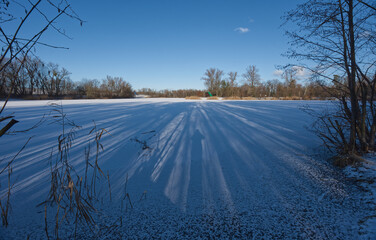 Frozen and snow covered lake in Park Bozeny Nemcove in Karvina city in Czech republic during winter