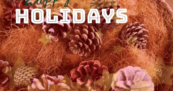 Animation of happy holidays text banner and stars floating over close up of pine cones