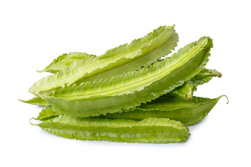 pile of winged beans, also known as cigarillas, manila or four-angled or goa beans, asparagus pea, tropical legume vegetable isolated on a white background